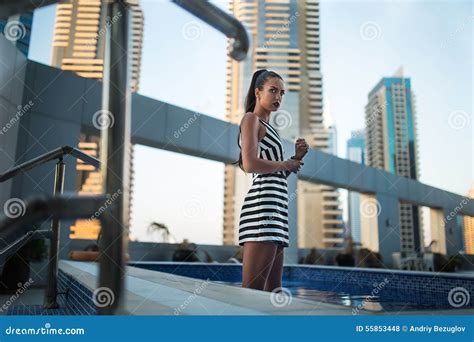 Beautiful Brunette In Striped Dress .